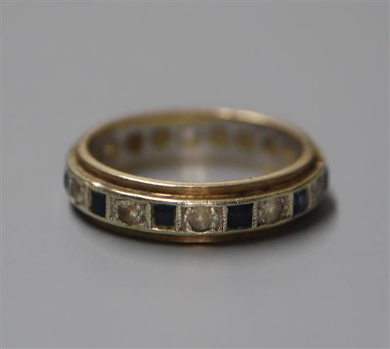 A 9ct yellow and white metal, two colour sapphire eternity ring, size L.